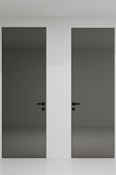 Two black doors with handles on a white wall.