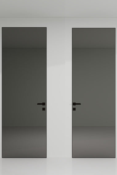 Two black doors with handles on a white wall.