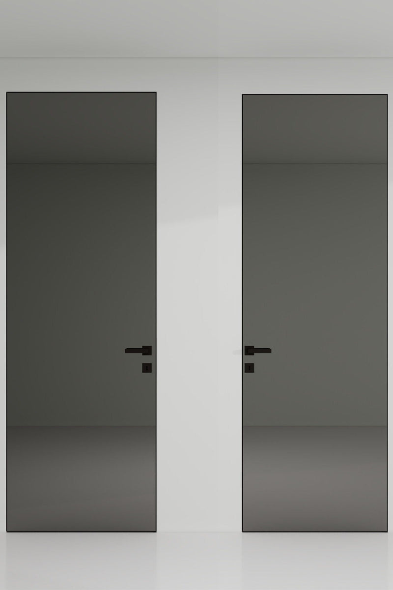 Two black doors with handles on a white wall.